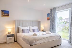 a bedroom with a large bed and a large window at 2 Bed in Sandown oc-90013 in Sandown