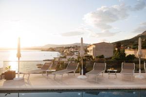a patio with chairs and a view of the water at Stella Maris in Podstrana