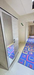 a room with a door with a carpet and a hallway at ARZON Halal Hotel in Tashkent