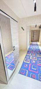 an empty hallway with a colorful carpet in a room at ARZON Halal Hotel in Tashkent