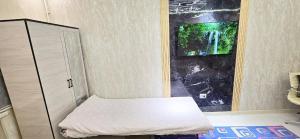 a small room with a bed and a window at ARZON Halal Hotel in Tashkent +76 photos