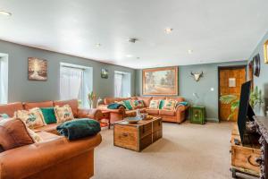 a living room with two couches and a table at 6 Bed in Holsworthy oc-89218 in Merryfield