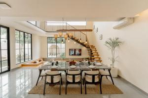 a large dining room with a table and chairs at Casa Amore 4BR Seminyak in Seminyak