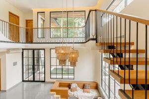a living room with a staircase and a couch at Casa Amore 4BR Seminyak in Seminyak +44 photos