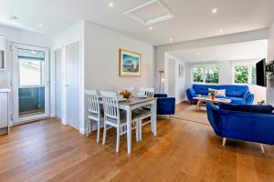 a living room with a table and a blue couch at 2 Bed in Croyde oc-18lead in Croyde