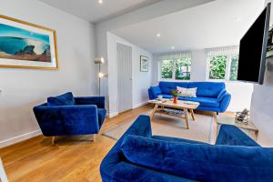 a living room with blue couches and a table at 2 Bed in Croyde oc-18lead in Croyde