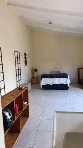 a bedroom with a bed in the corner of a room at Espaço Luz & natureza in Juazeiro do Norte