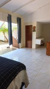 a bedroom with a bed and a tiled floor at Espaço Luz & natureza in Juazeiro do Norte +23 photos