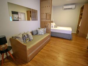 a small room with a bed and a mirror at ibis Styles Bonito in Bonito +130 photos