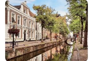 a canal in the middle of a city with buildings at O21 Apartment in Amersfoort