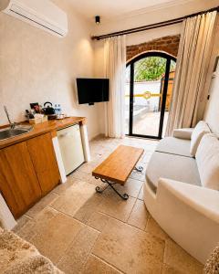 a living room with a couch and a table at Adyton Guest House in Didim