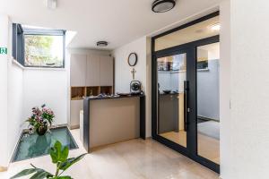 a pivot door in a room with a kitchen at Stella Maris Beach in Podstrana