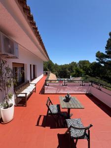 a patio with benches and a table on a building at Villa Allyson Boutique Guesthouse in Lloret de Mar