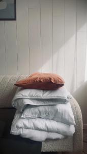 a stack of white pillows sitting on a bed at Airport Moonlight Tallinn in Tallinn +2 photos