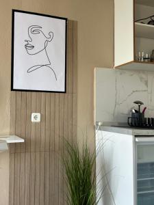 a drawing of a woman on a wall in a kitchen at Basilio's Studios in Leptokarya