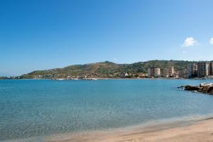 a view of a beach with a mountain in the background at Blue Bay Suite & Spa in Agropoli