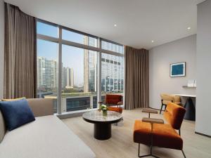 a living room with a view of a city at Novotel Chengdu Lige in Chengdu