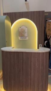 a wooden counter with a yellow chair in a room at GUELIZ Seven Stays in Marrakesh
