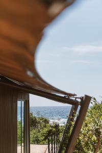 a view of the ocean from a house window at The Revery, Elafonisi - Member of Leading Hotels of the World in Livadia