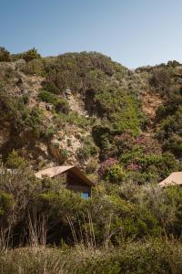 a house on the side of a mountain at The Revery, Elafonisi - Member of Leading Hotels of the World in Livadia