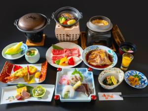 a table topped with plates of food and drinks at Hotel Luna Park in Matsuyama +8 photos
