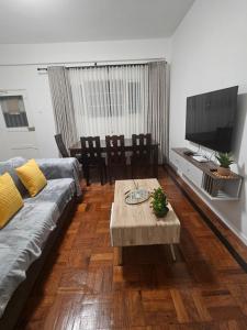 a living room with a couch and a coffee table at Luxury Comfort House in Maputo
