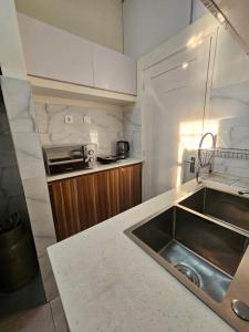a kitchen with a sink and a counter at Luxury Comfort House in Maputo