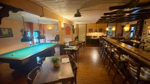a bar with a pool table in a restaurant at Domaine de Maples in Dore-lʼÉglise