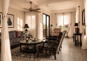 a living room with a couch and a table at RoofTop Boutique Hotel Adults Only in Serekunda