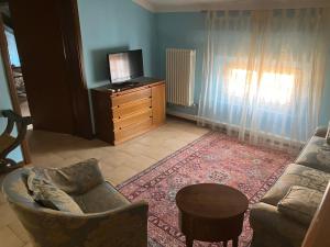 a living room with a couch and a tv at Fondobanchetto in Ferrara
