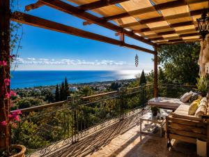 a balcony with a view of the ocean at A historic STONE VILLA with private garden, terrace and private pool just for you in Kyrenia