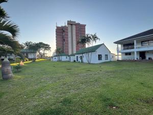 a large yard with houses and a tall building at Siesta Island #5 in Amanzimtoti