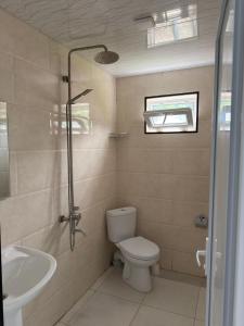 a bathroom with a toilet and a sink at Hotel Palm Gonio in Kvariati