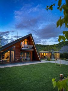 a large house with a gambrel roof at Luxury Aframe in Râşnov