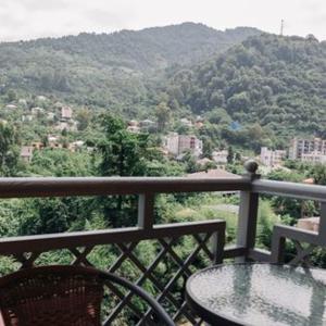 a balcony with a table and a view of a mountain at Hotel Scorpio gonio in Gonio