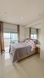 a bedroom with a large bed and a large window at SHB - Refinement, Ocean View, Sauna and Pool! in Santos +96 photos