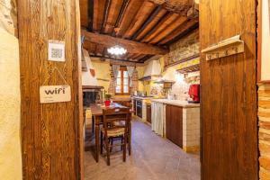 a large kitchen with a table and chairs in it at Beb Pulcino Nero Scrofiano in Scrofiano +25 photos