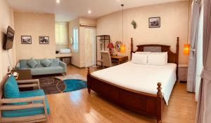 a bedroom with a bed and a living room at Tranquility Stay Old Quarter in Hanoi