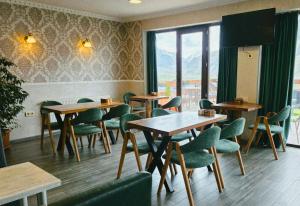 a restaurant with tables and chairs and a window at Sunshine Kazbegi in Kazbegi +34 photos
