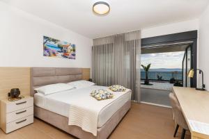 a bedroom with a bed and a view of the ocean at Stella Maris Deluxe in Podstrana +38 photos