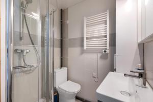 a bathroom with a toilet and a shower and a sink at Chambres D'hôtes La Maison Rouge - in Contres