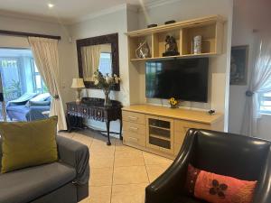 a living room with a couch and a television at Bonne Esperance in Tyger Valley