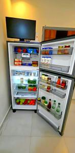 a refrigerator with its door open with food inside at Solara in Hurghada