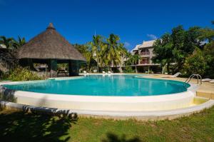 a swimming pool at a resort with a gazebo at Beachfront Duplex with Estate Pool in Bain Boeuf