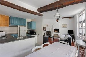 a kitchen and living room with a bed in a room at Coeur de Ville - Beaugency in Beaugency