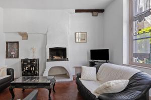 a living room with a couch and a fireplace at Coeur de Ville - Beaugency in Beaugency