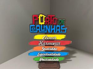 a group of colorful signs on a wall at Flat no centro VDP314 - Rooftop in Porto De Galinhas