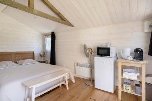 a bedroom with a bed and a tv in it at Chalet La Bienvenue in Vouzon +12 photos