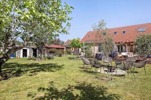 a group of chairs and a table in a yard at Chalet La Bienvenue in Vouzon