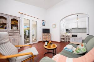 a living room with a couch and a table at Villa Gelabert Ametller in Cala en Bosc